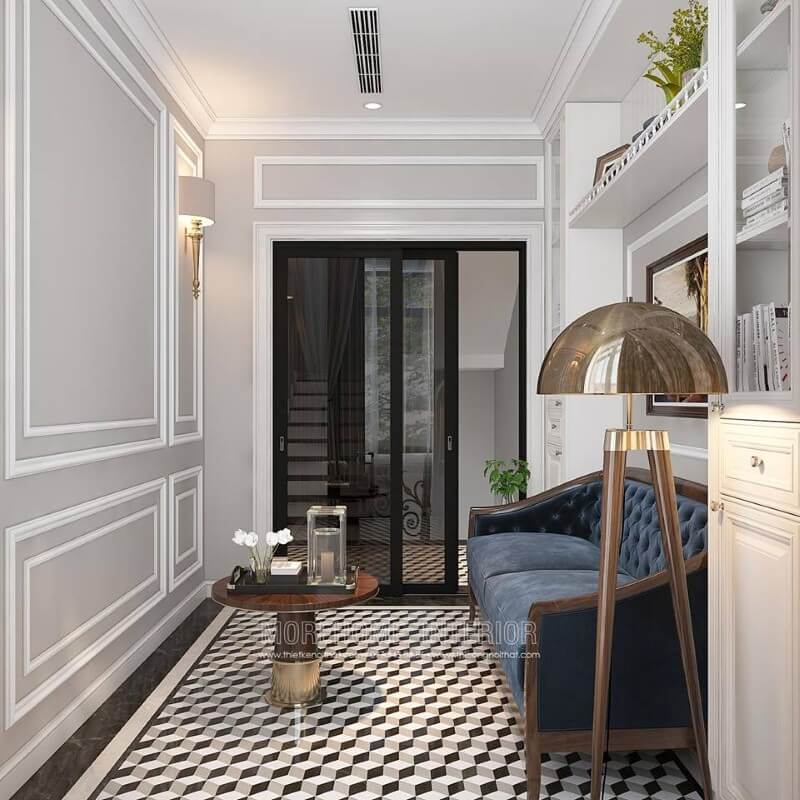 Gạch lát nền giả cổ, sofa đơn gỗ óc chó tân cổ điển bọc nệm xanh cùng tường trắng đơn sắc đã tạo nên không gian đẹp sang trọng, đáp ứng tối đa công năng cho phòng đọc sách. thiết kế biệt thự tân cổ điển
