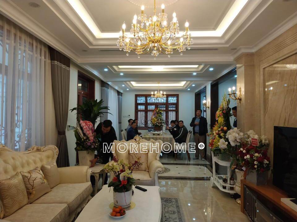Không gian phòng khách tân cổ điển được bày trí bộ sofa da, đèn chùm, kệ trang trí cao cấp,... Thiết kế nội thất biệt thự đẹp, sang trọng