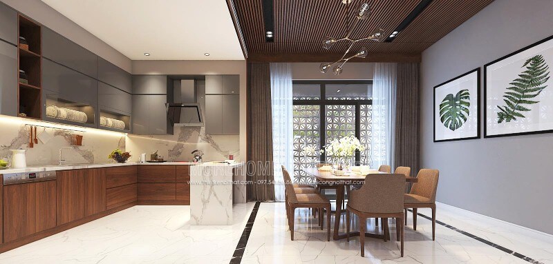 Sắp xếp nội thất phòng bếp liền phòng ăn sang trọng, độc đáo với nội thất gỗ chủ đạo từ tủ bếp, bộ bàn ghế, tường ốp gỗ tại biệt thự, nhà phố Vinh, Nghệ An. Thiết kế biệt thự